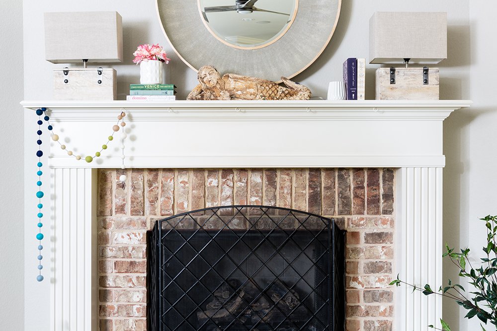 Before and After: A Fresh + Cozy Waco Living Room designed by Lesley Myrick. Love this pretty fireplace mantel.