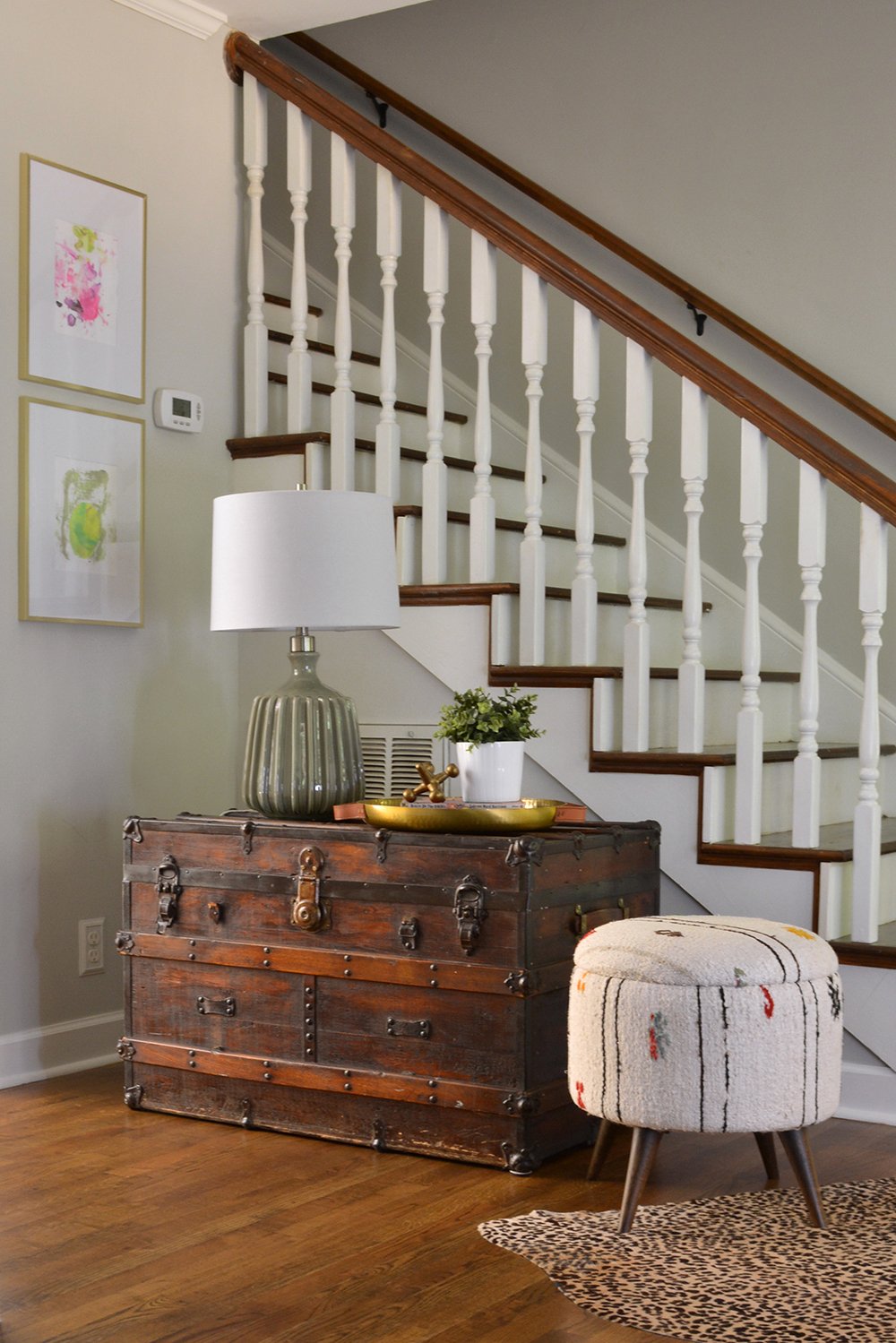 Sherwin Williams Agreeable Gray is a perfect neutral for entryways and stairwells. Designed by Lesley Myrick Interior Design.
