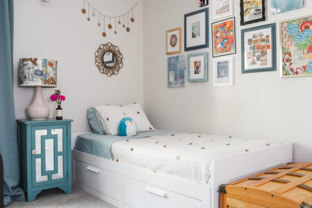 A cute girl's bedroom with white, aqua, and pink