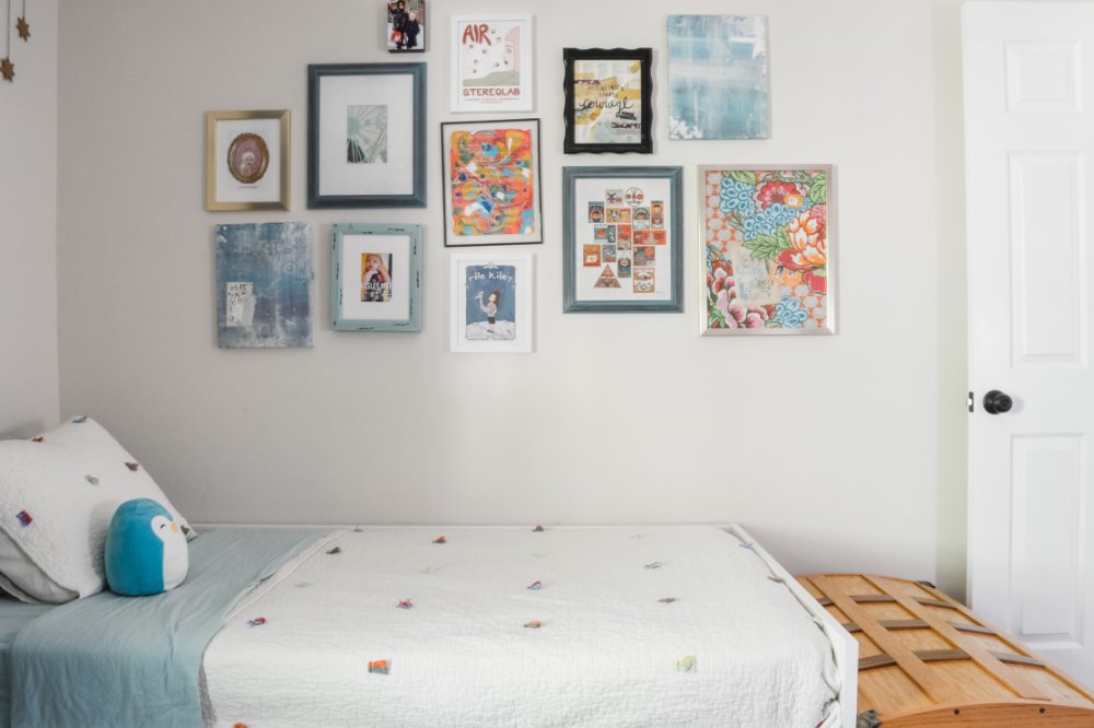 A colorful gallery wall in a preschooler's bedroom