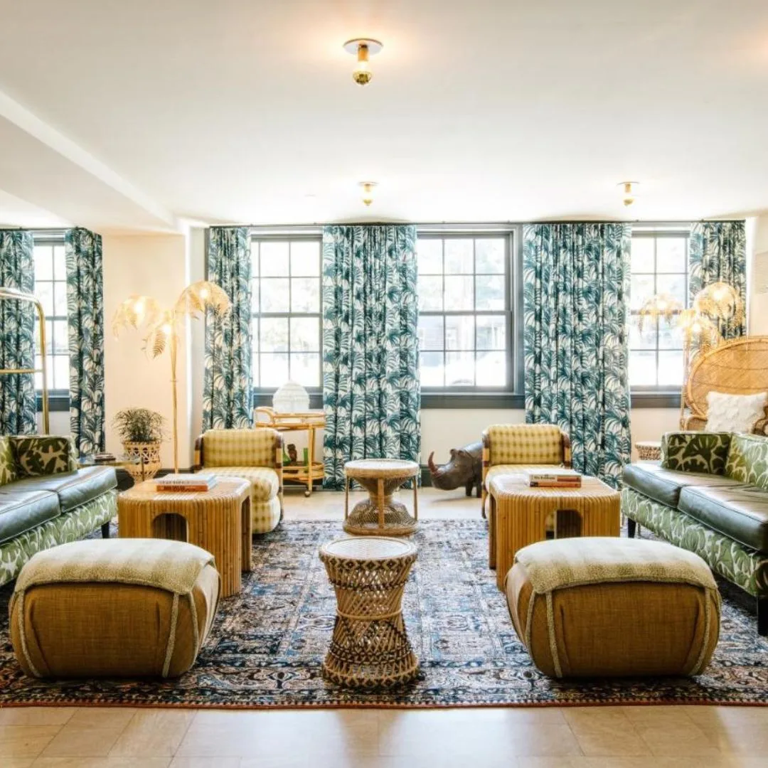 Hotel lobby featuring elegant blue and green curtains, creating a vibrant and welcoming atmosphere for guests.