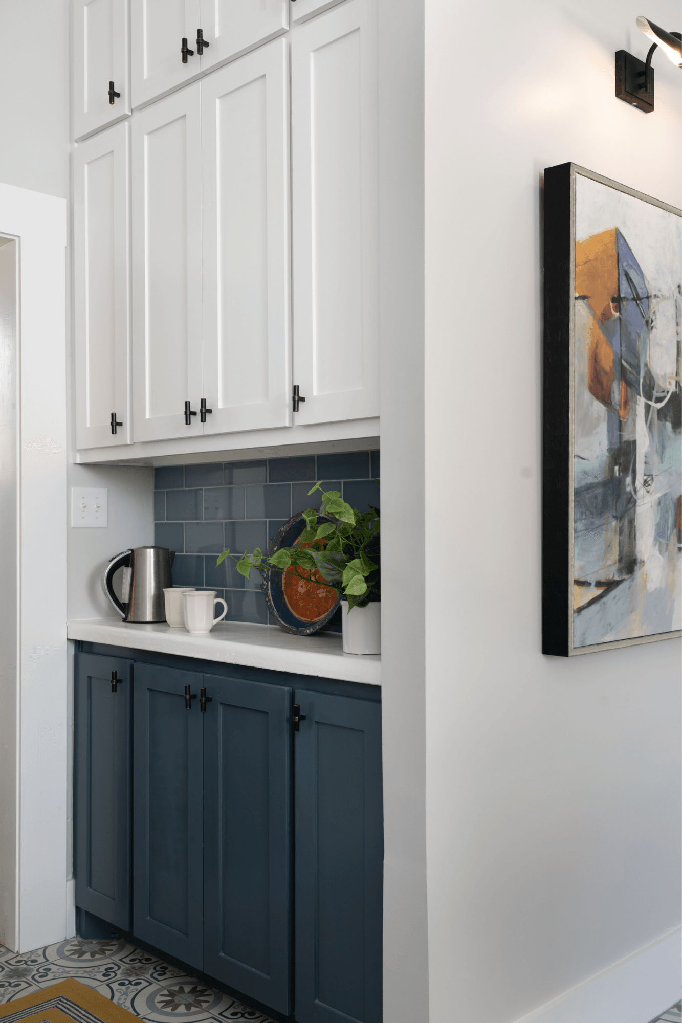 An integrated coffee bar turned a shallow nook into usable floor-to-ceiling storage, with a dedicated zone for tea and coffee prep in this kitchen remodel by interior designer Lesley Myrick.