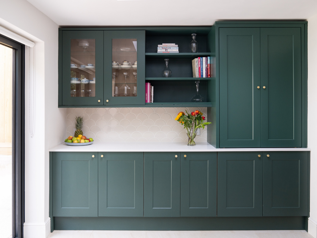 A high-end kitchen's butler's pantry in teal and white.
