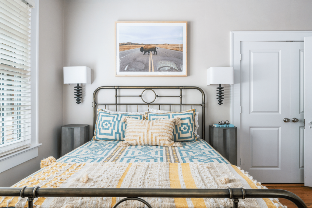A boys' bedroom in grey, blue and yellow with buffalo art by Lesley Myrick Interior Design in Atlanta, GA