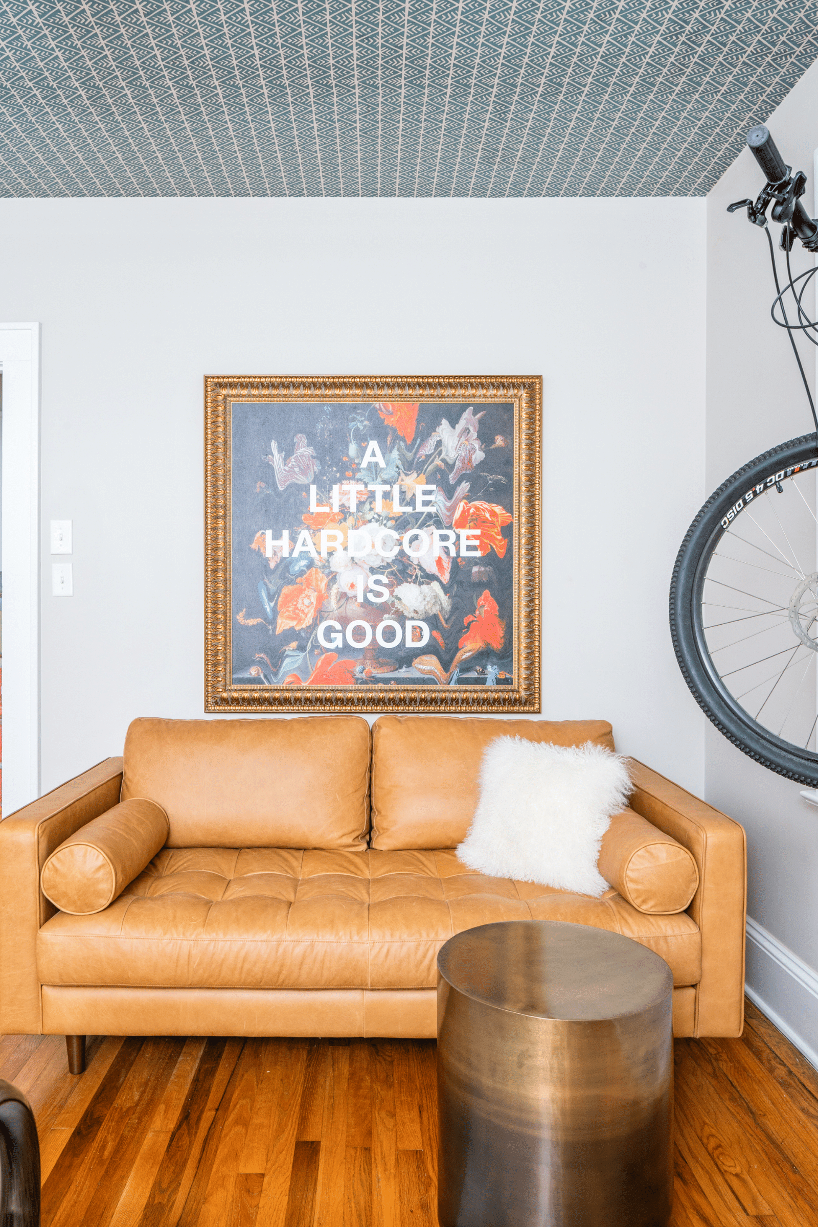 Hardcore art and a mountain bike bring a fun and adventurous vibe to this Atlanta bedroom by luxury interior designer Lesley Myrick