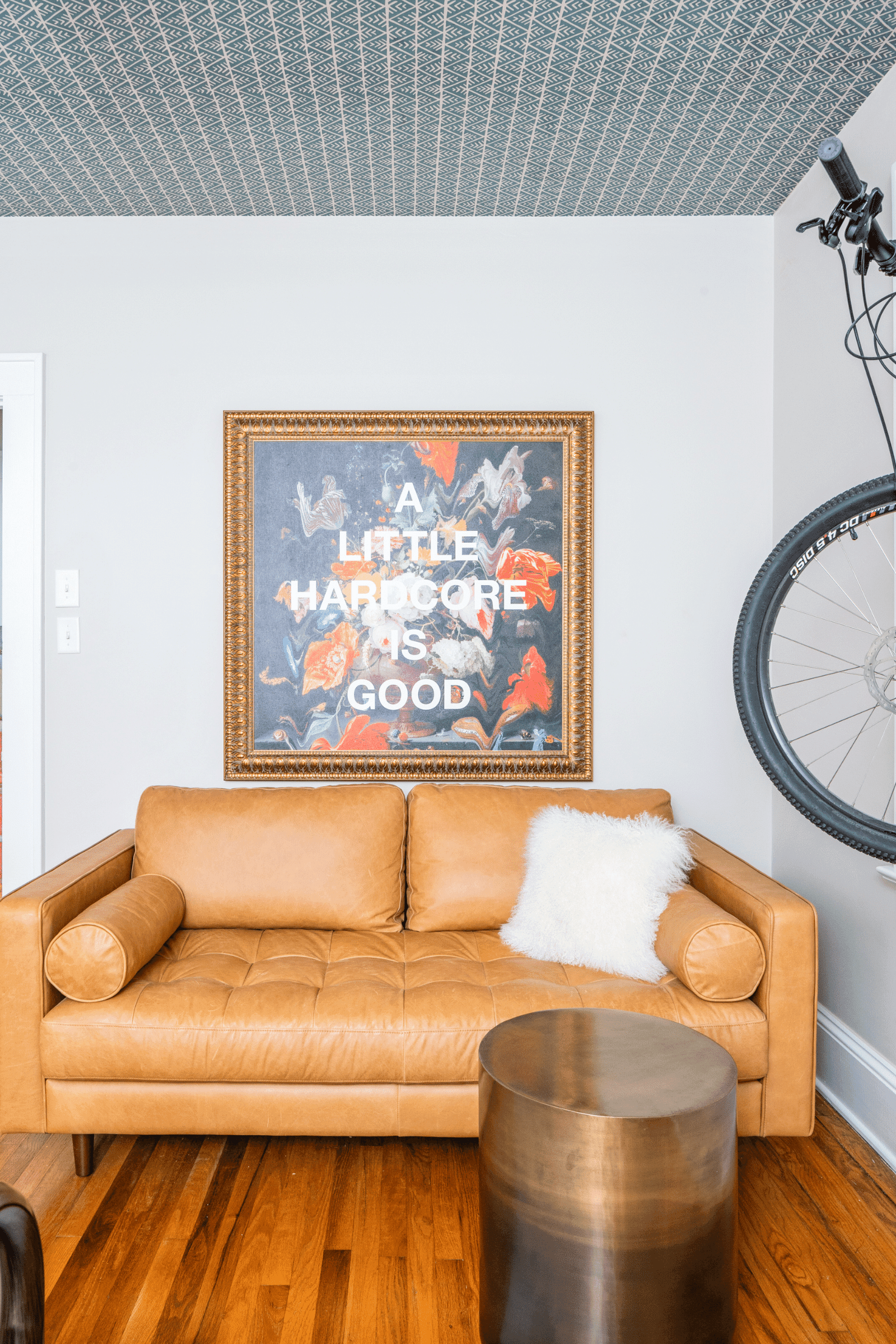 Hardcore art and a mountain bike bring a fun and adventurous vibe to this Atlanta bedroom by luxury interior designer Lesley Myrick