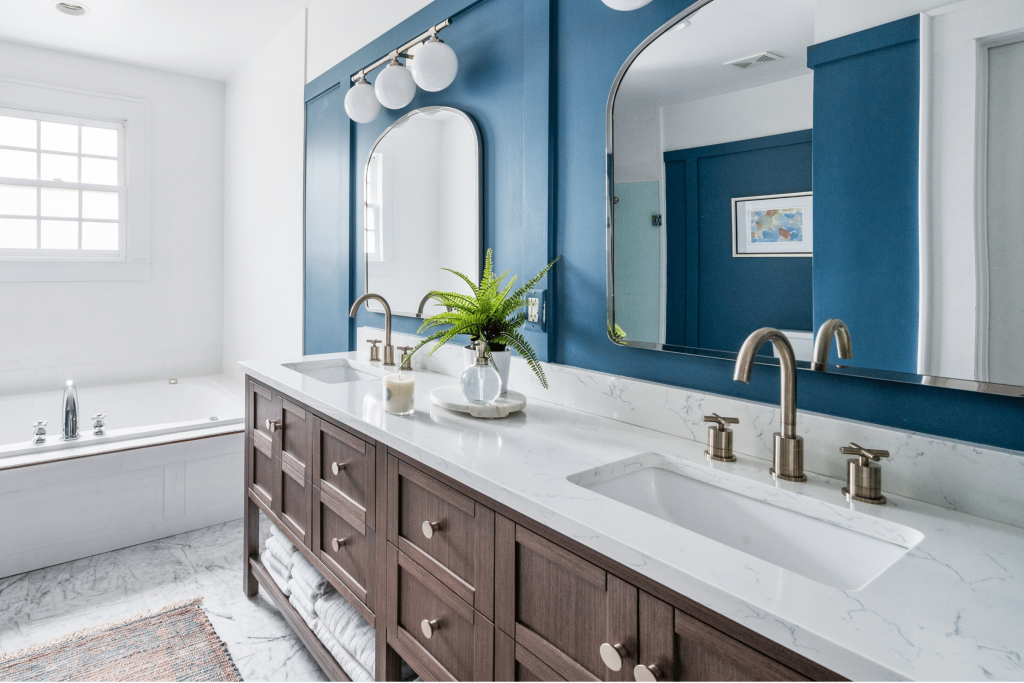 A luxe coastal-inspired blue primary bathroom in Macon, GA, designed by Lesley Myrick Interior Design