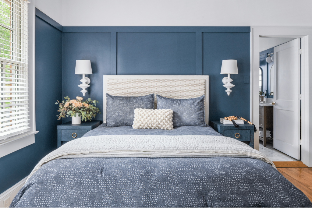 A luxe coastal-inspired dark blue primary bedroom in Macon, GA, designed by Lesley Myrick Interior Design