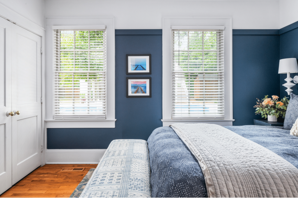 A luxe coastal-inspired blue primary bedroom with white trim in Macon, GA, designed by Lesley Myrick Interior Design