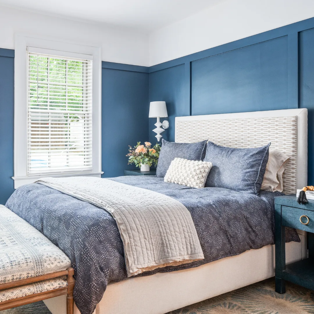 A solid blue wall, providing a vibrant and calming backdrop in a minimalist setting.