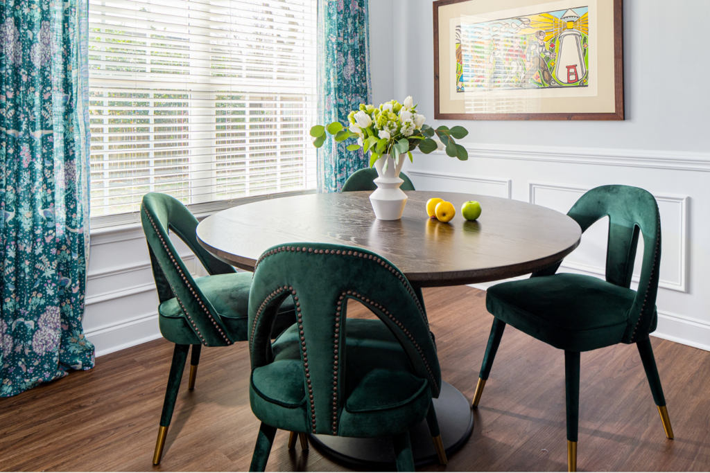 Modern breakfast nook dining room with green velvet chairs and a tulip table, designed by Atlanta luxury designer Lesley Myrick Interior Design.