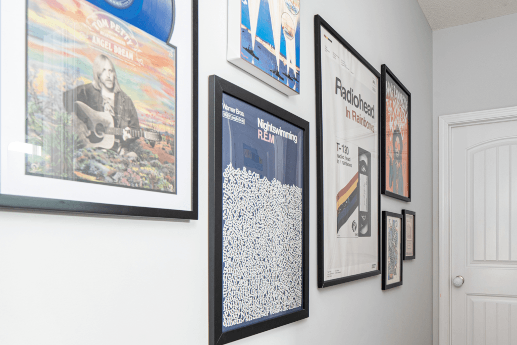 Gallery wall with music memorabilia by Atlanta interior designer Lesley Myrick