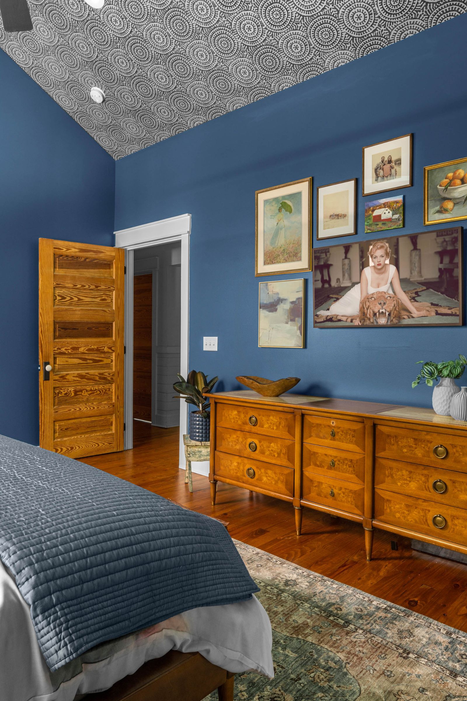 Navy blue farmhouse bedroom gallery wall - full-service interior design project - by Lesley Myrick Interior Design in Macon, GA