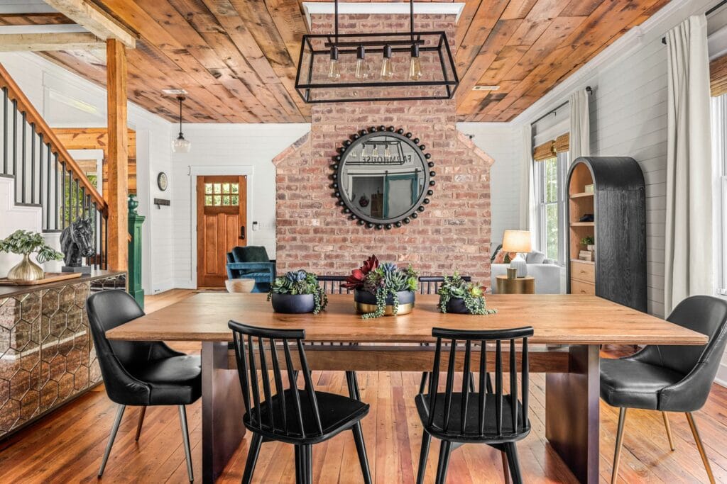 Farmhouse dining room with black Windsor chairs by Lesley Myrick Interior Design