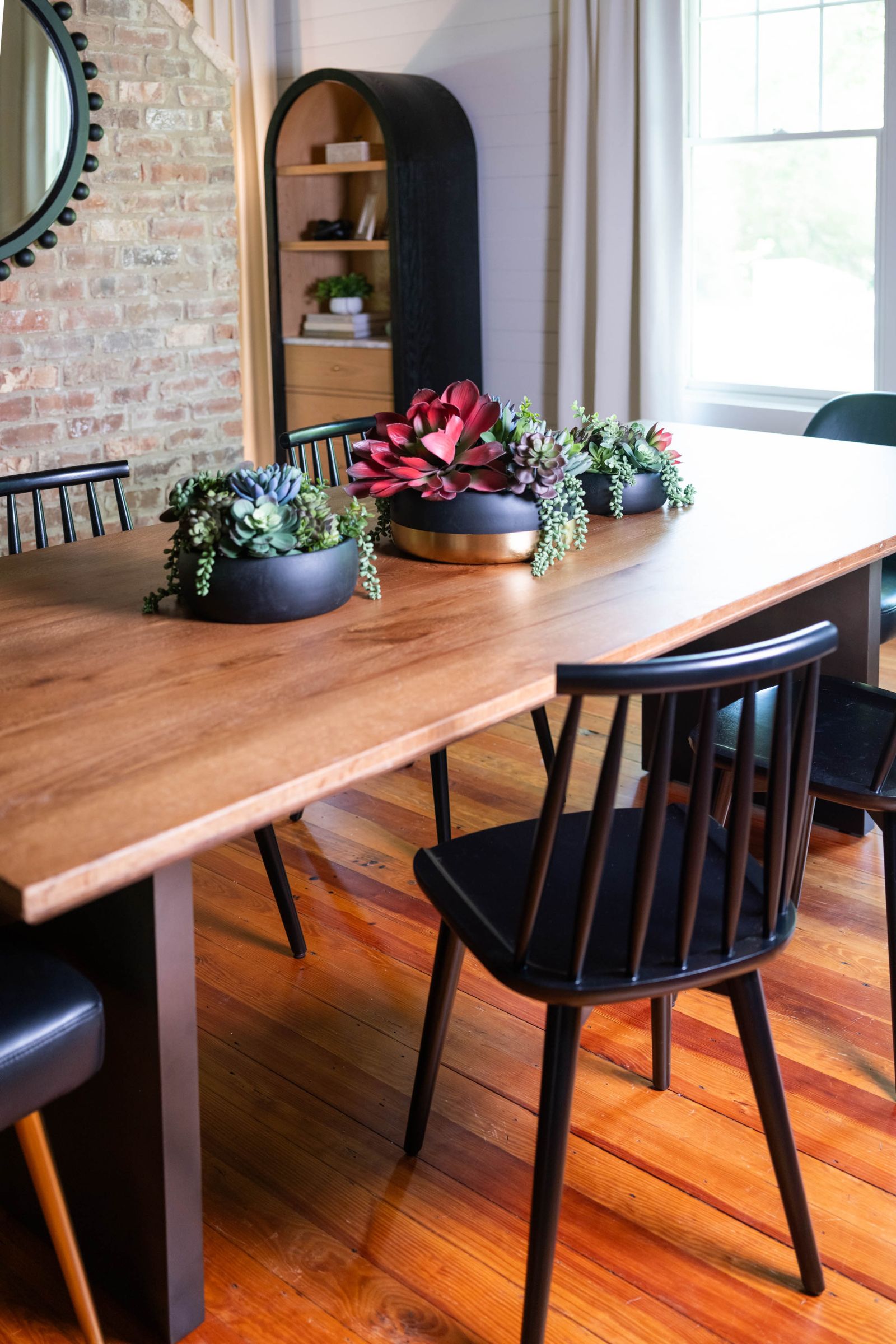 Farmhouse dining room with black Windsor chairs by Lesley Myrick Interior Design