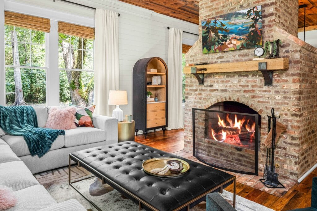 Farmhouse living room design with leather ottoman by Lesley Myrick Interior Design