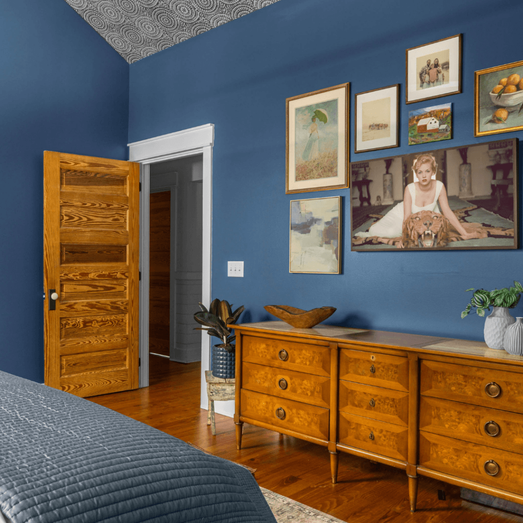 Blue farmhouse bedroom gallery wall by Lesley Myrick Interior Design in Macon, Georgia