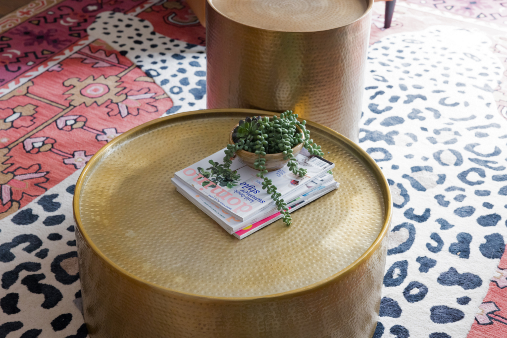 Hammered brass coffee tables in a colorful living room