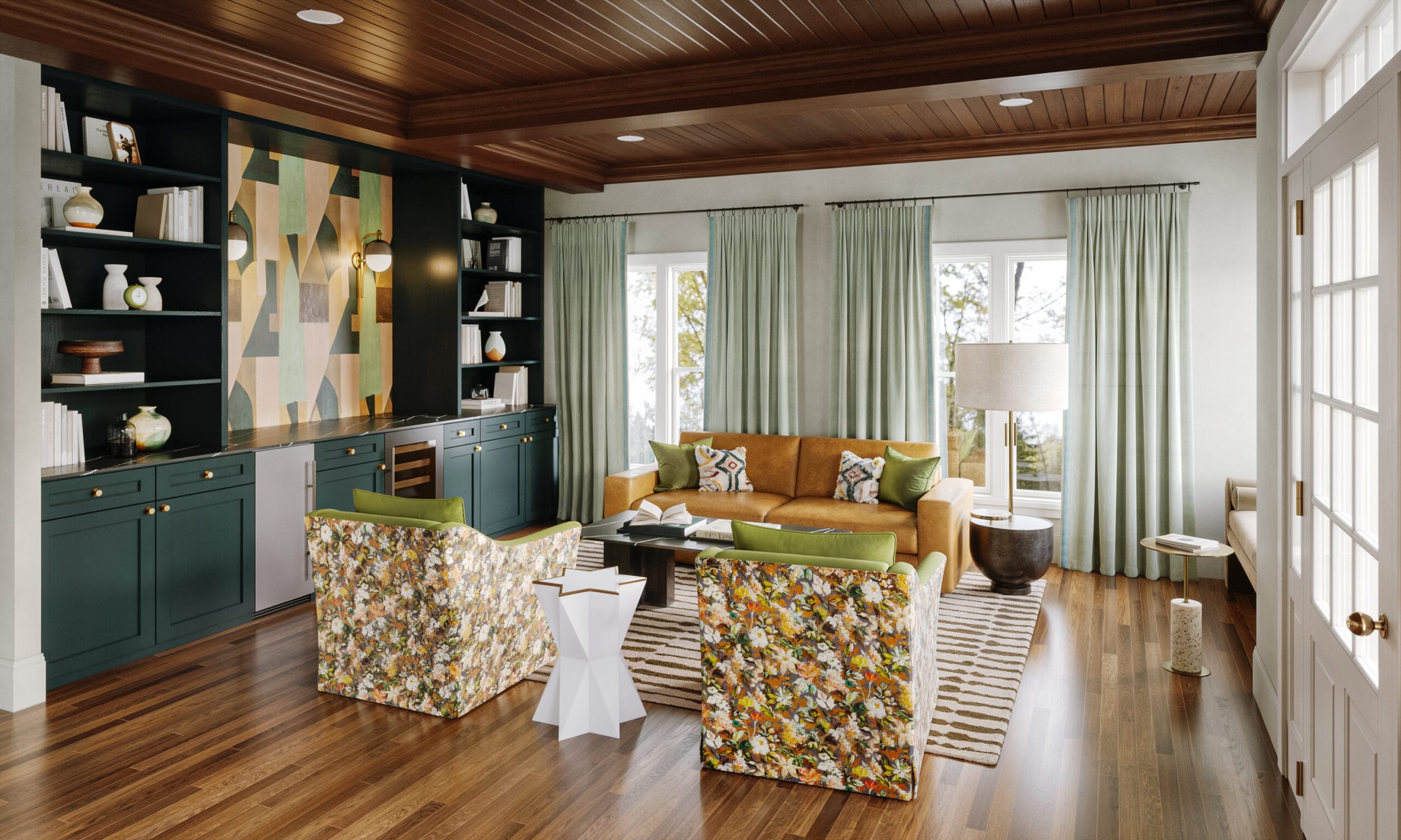 Bold geometric wallpaper inside a dark green built-in bookcase adds personality to a modern lounge with a leather sofa and floral chairs by Macon interior designer Lesley Myrick.