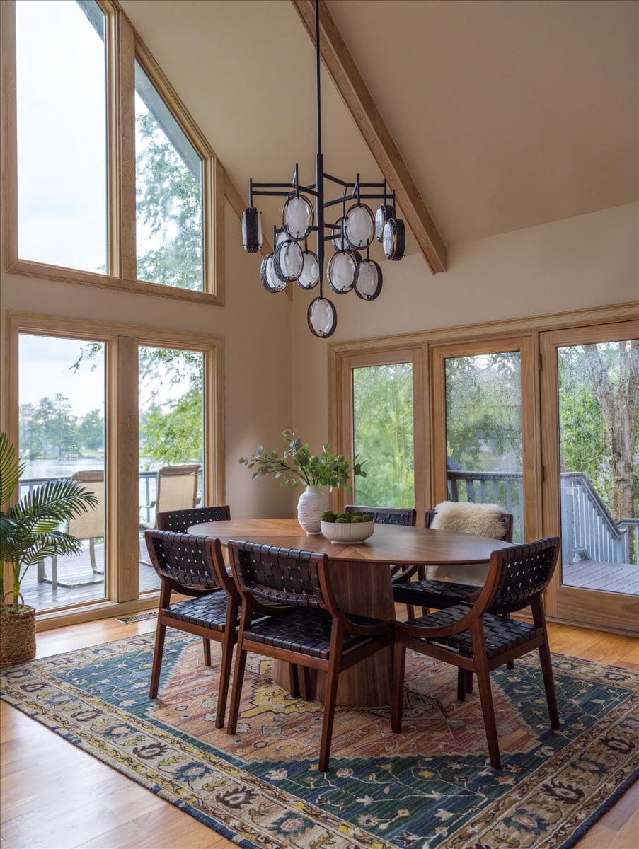 Wide view of Lake Sinclair living and dining area with modern furniture and lake-facing windows.