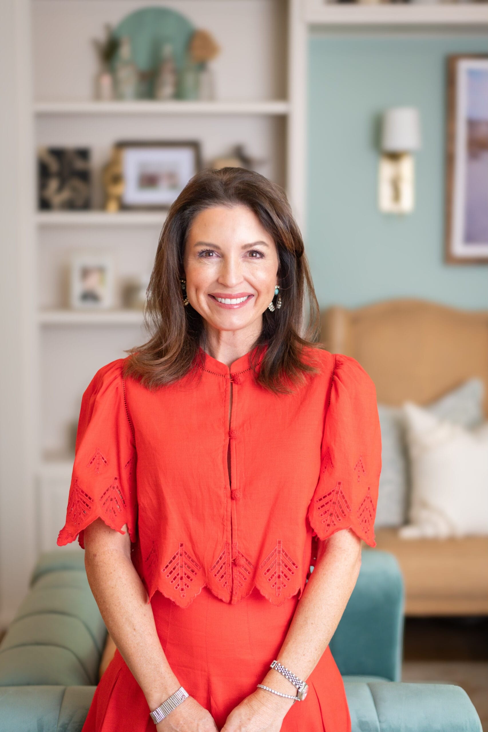 Portrait of Windy Deham, Macon professional organizer and owner of NEAT Method Macon, standing in a living room with a warm smile.