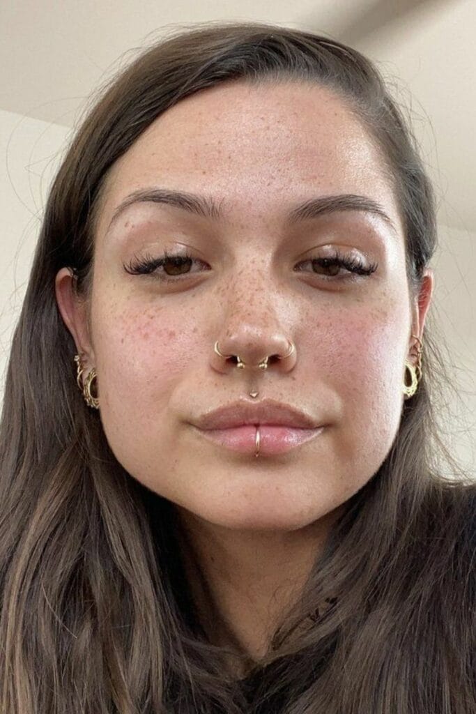 Clean girl look with delicate facial piercings