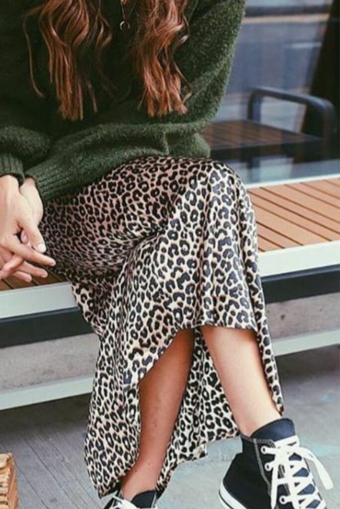 Pattern mixing with a green knit, leopard print silk, and black canvas shoes shows how personal style and interior design relate