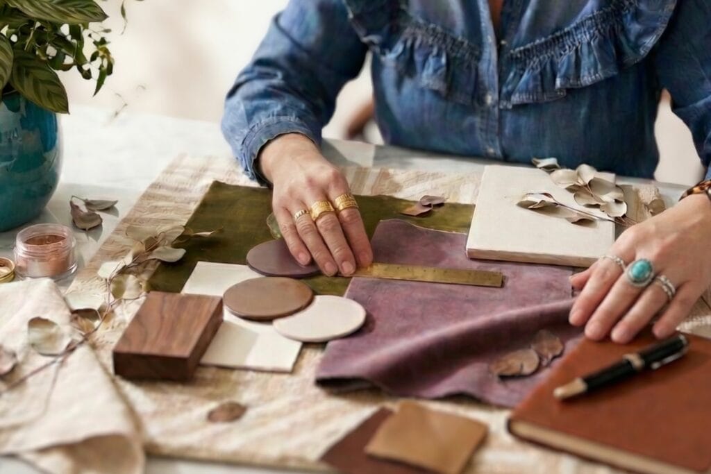 [AI generated image] Interior designer Lesley Myrick arranges fabrics, carpet, and tile samples during an interior design consultation
