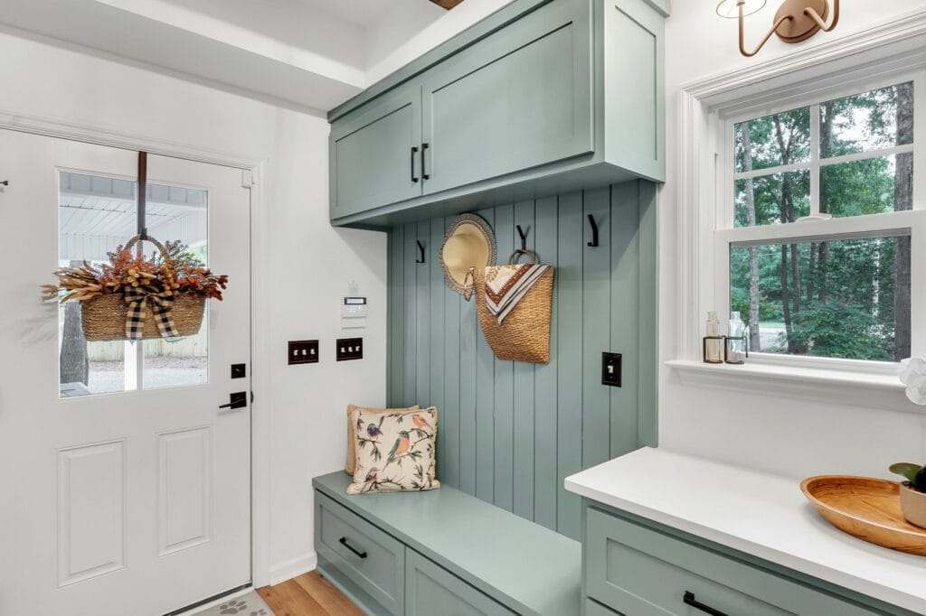 Mudroom renovation with aqua cabinets by Sara Barron Designs.