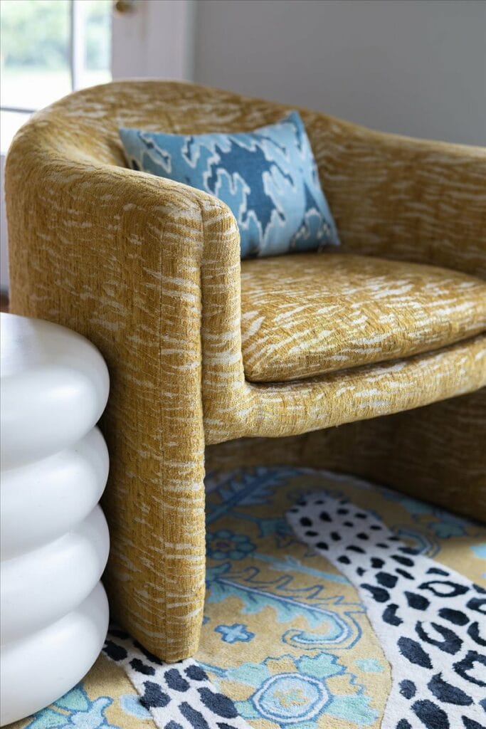 Mustard yellow textured accent chairs and a sculptural end table in a living room designed by Macon Interior Designer Lesley Myrick.