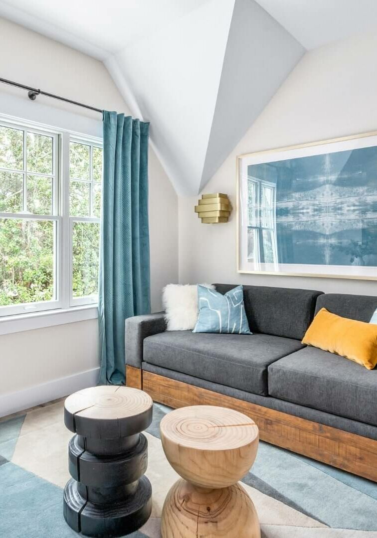A modern kitchen featuring blue chairs and white cabinets, creating a bright and inviting atmosphere.